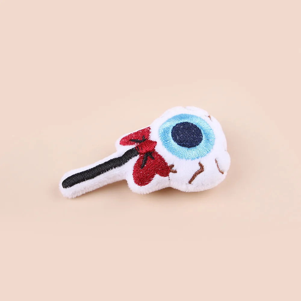 Plush cat wand toy with 27cm handle showing three interchangeable colourful heads: eyes, candy, and skull designs