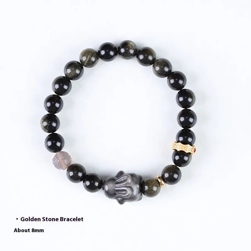 Handmade lying rabbit obsidian bracelet in brass with grey agate, showing national style design.