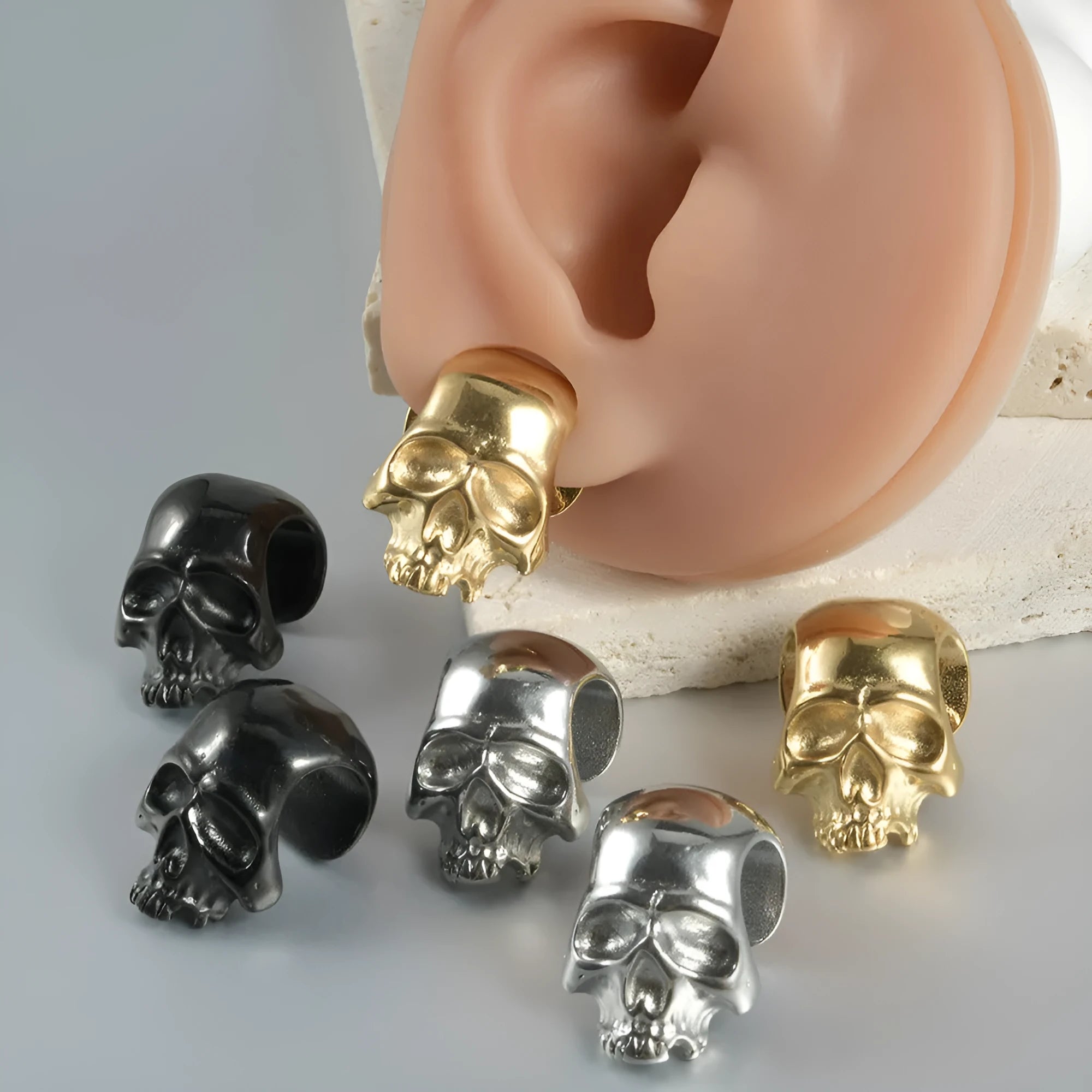Stainless steel hollow skull Buddha earrings with geometric designs in four electroplated colour finishes