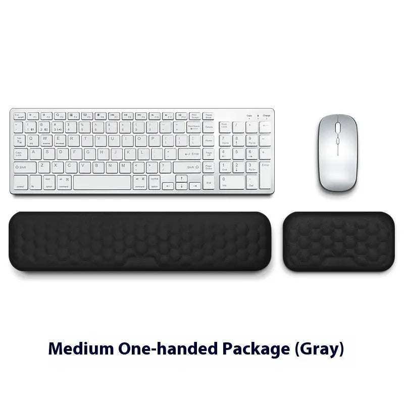 Customisable memory foam mouse wrist pad with black cloth cover on a desk.