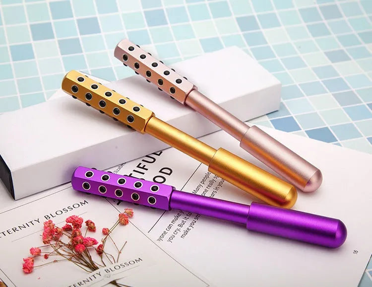 Purple handheld beauty massage roller with germanium particles for facial treatment