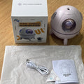 Purple astronaut-shaped USB desktop humidifier with LED light on wooden desk