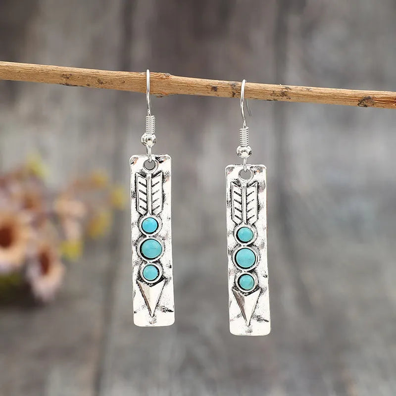 Silver geometric earrings with turquoise inlay on long strip zinc alloy design