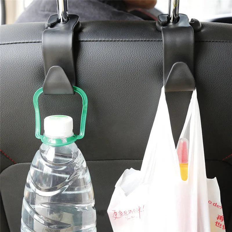 Set of 4 black PP universal car seat back hooks, each 11cm x 3.5cm, with 20kg weight capacity, for hanging bags from car front seat backs