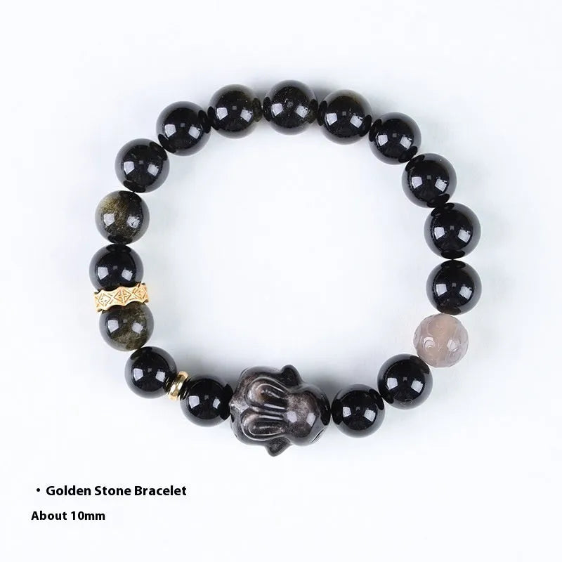 Handmade lying rabbit obsidian bracelet in brass with grey agate, showing national style design.