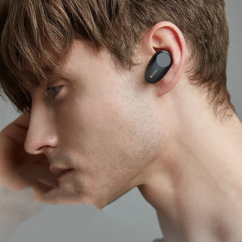 Black wireless Bluetooth headphones with charging stand showing Type-C and wireless charging options