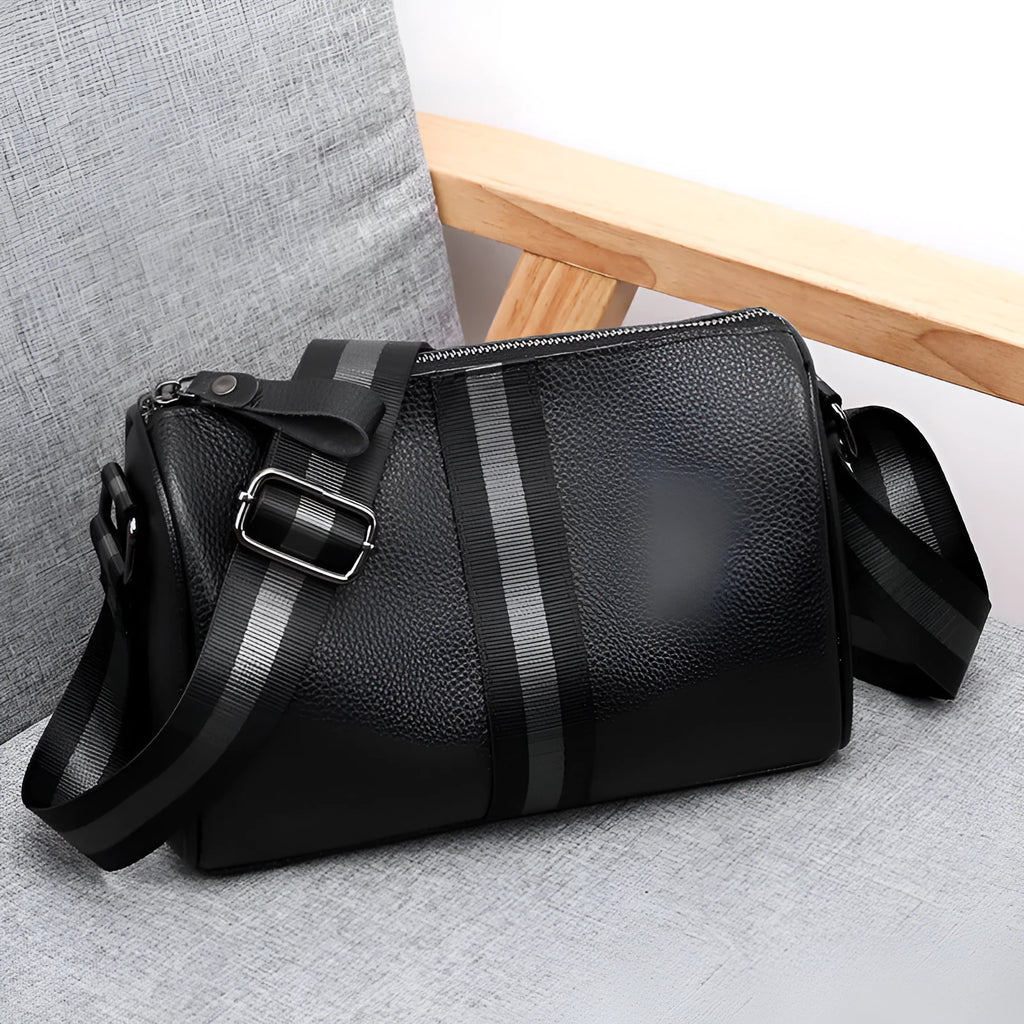 Black genuine leather one-shoulder crossbody bag showing front and side view.