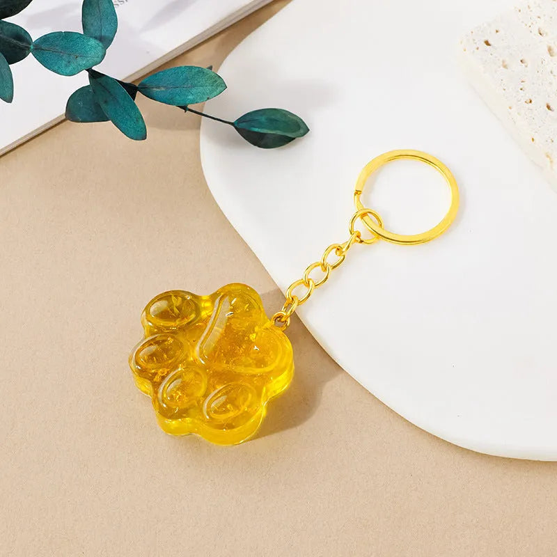 Small natural crystal cat's paw shaped pendant on a metal keyring, available in various crystal colours.