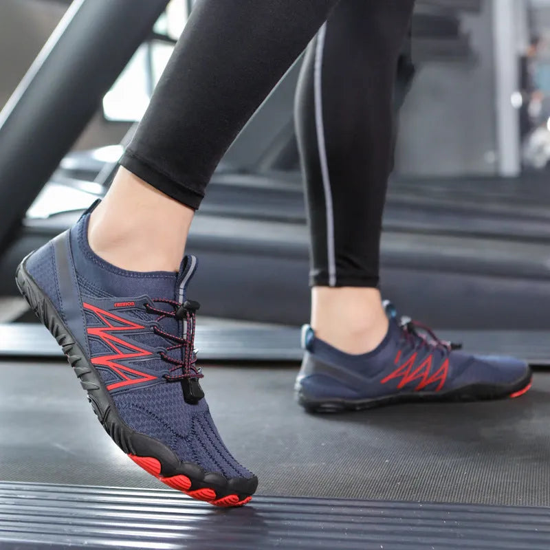 Low-top striped training sneakers with a flat rubber sole, shown in various colours including black and grey orange.