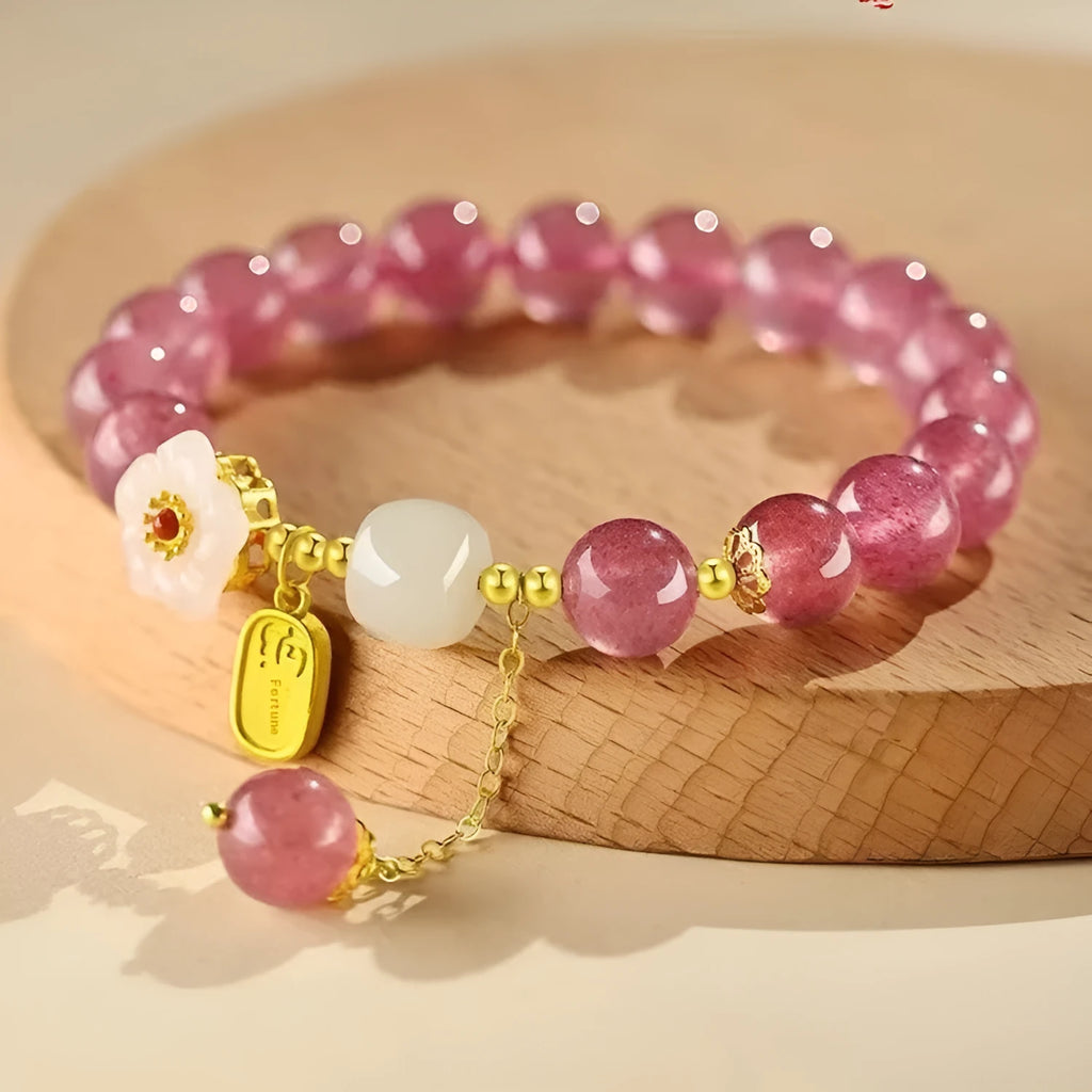 Handcrafted strawberry quartz crystal bracelet with green moon beads and peach blossom Hetian jade charm on adjustable string