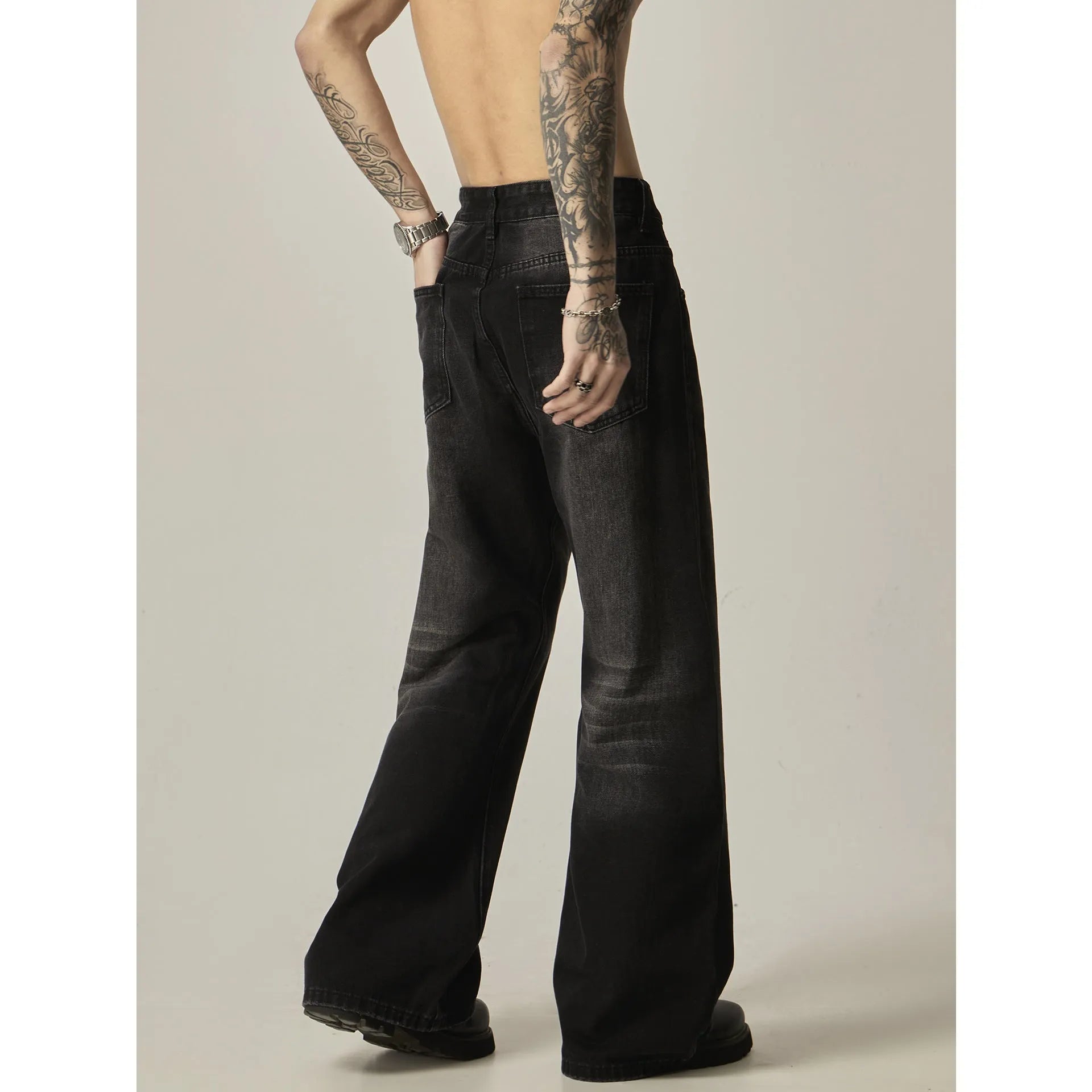 Black loose straight cut retro jeans with zipper fly on mannequin showing full silhouette