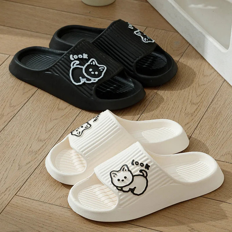 Green cat design thick EVA platform slippers on a wooden floor
