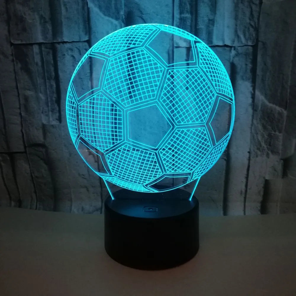 3D football-shaped LED night light showing colour gradient on acrylic panel with touch control base.