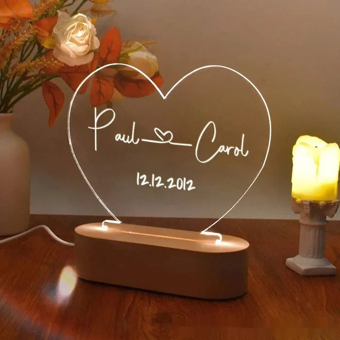 Custom engraved acrylic LED night light showing illuminated personal names and dates