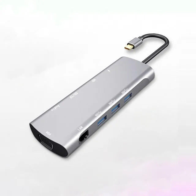Grey aluminium USB-C docking station showing HDMI, VGA, USB 3.0, and power delivery ports