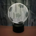 3D football-shaped LED night light showing colour gradient on acrylic panel with touch control base.