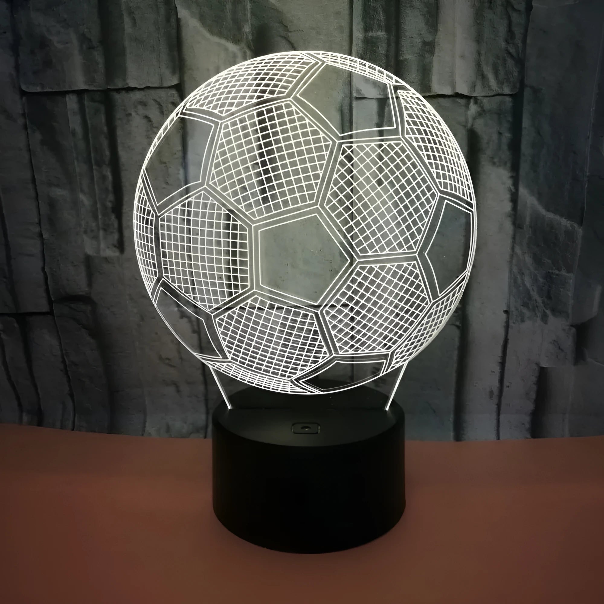 3D football-shaped LED night light showing colour gradient on acrylic panel with touch control base.