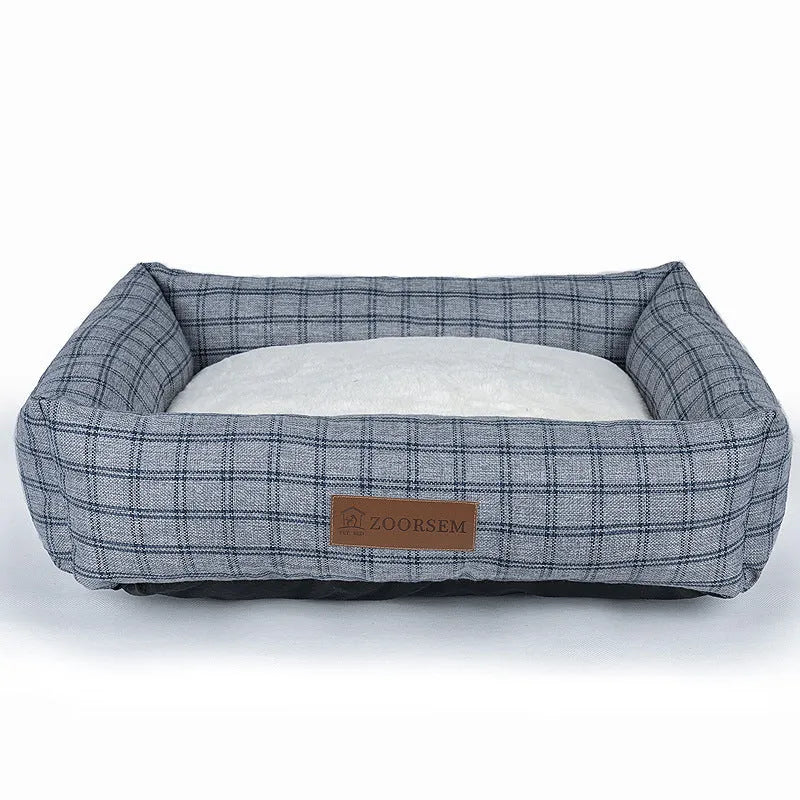 Grey plaid linen square dog bed for medium-sized dogs on a wooden floor.