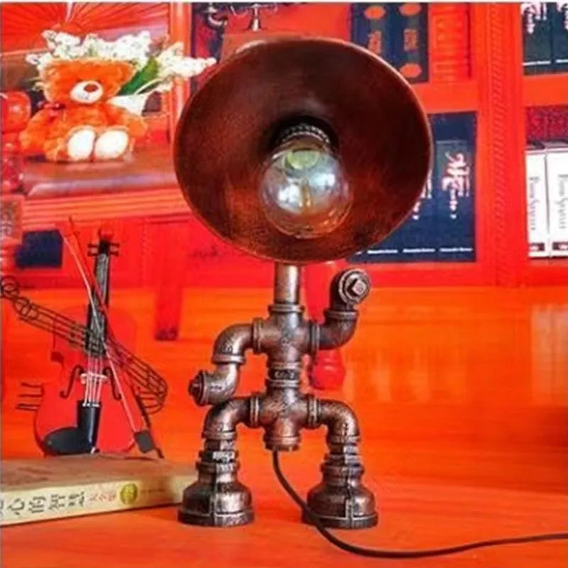 Industrial retro table lamp made from iron water pipes in vintage colour on a wooden desk