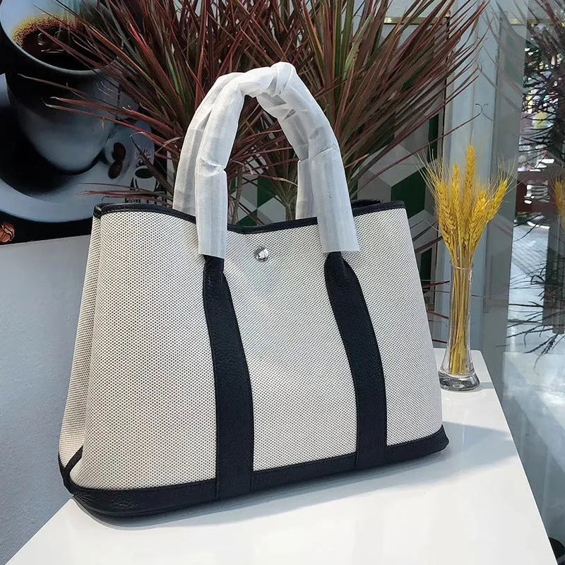 Women's canvas crossbody shoulder tote bag with leather detailing and bucket shape