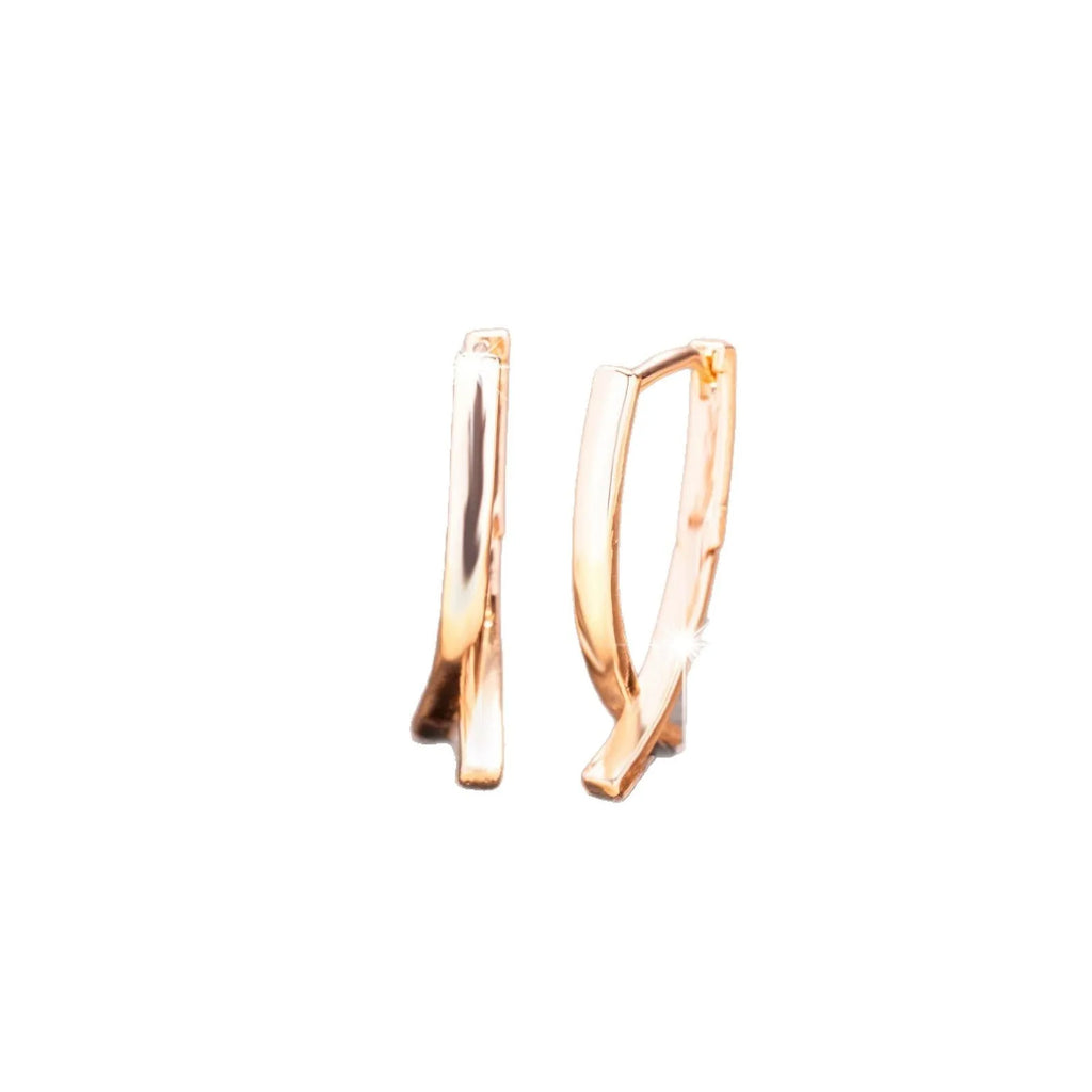 A pair of rose gold cross shaped fashion earrings on a copper alloy base.