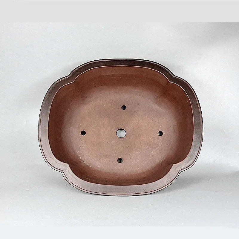Handmade antique crabapple shaped purple clay flowerpot for plants.