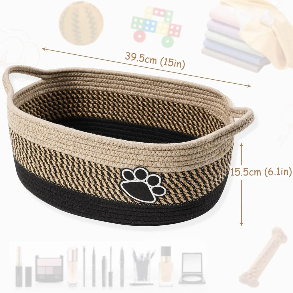 Light beige handmade cotton rope woven storage basket with a wooden handle on a table.
