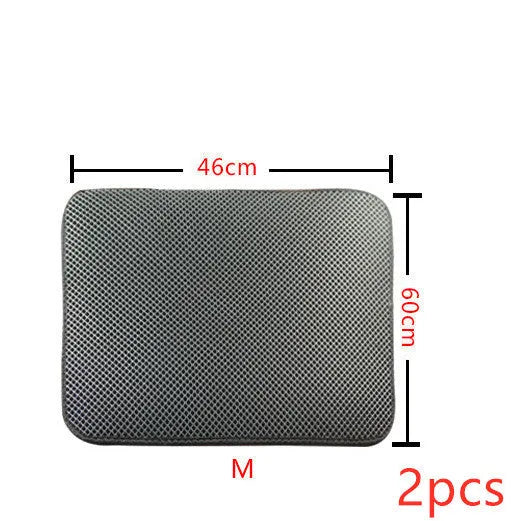 Double layer EVA cat litter mat in black with textured surface, placed under a litter box to trap debris