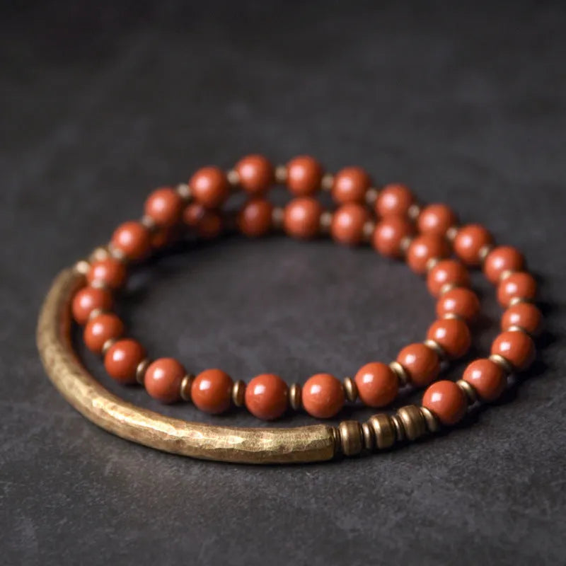 Layered ethnic bracelet with natural agate stones and brass charms on wrist