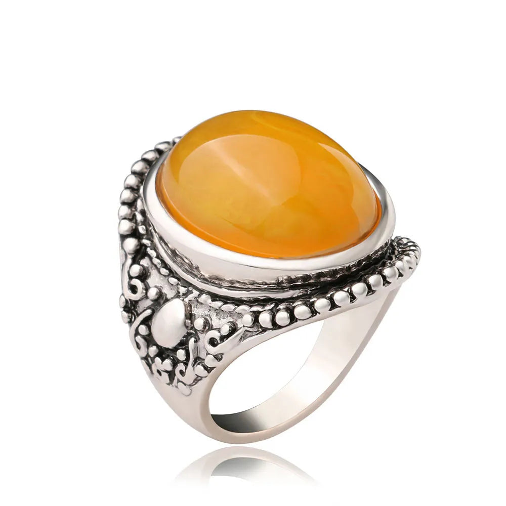 Close-up of a geometric retro ring in antique silver amber with a beeswax fluorescent finish.