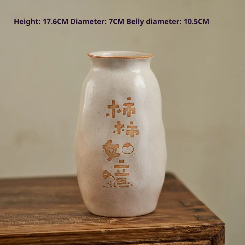 Chinese hand-painted ceramic vase with persimmon fruit designs on wooden desktop