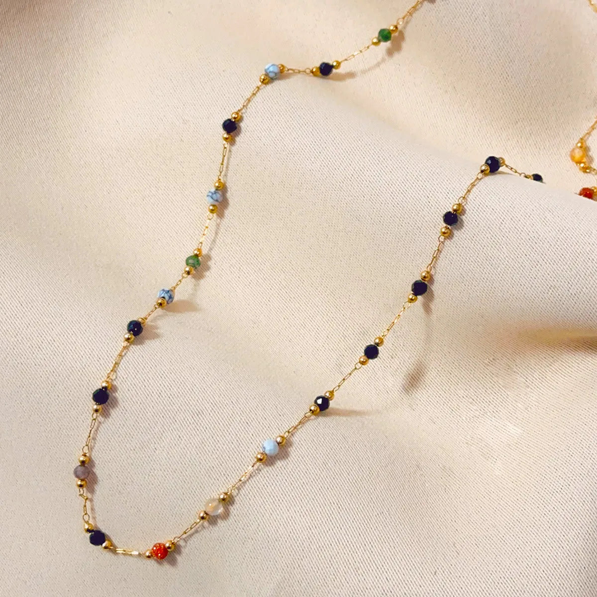 Gold titanium steel necklace with natural stone pendant showing O-ring chain and retro simple design