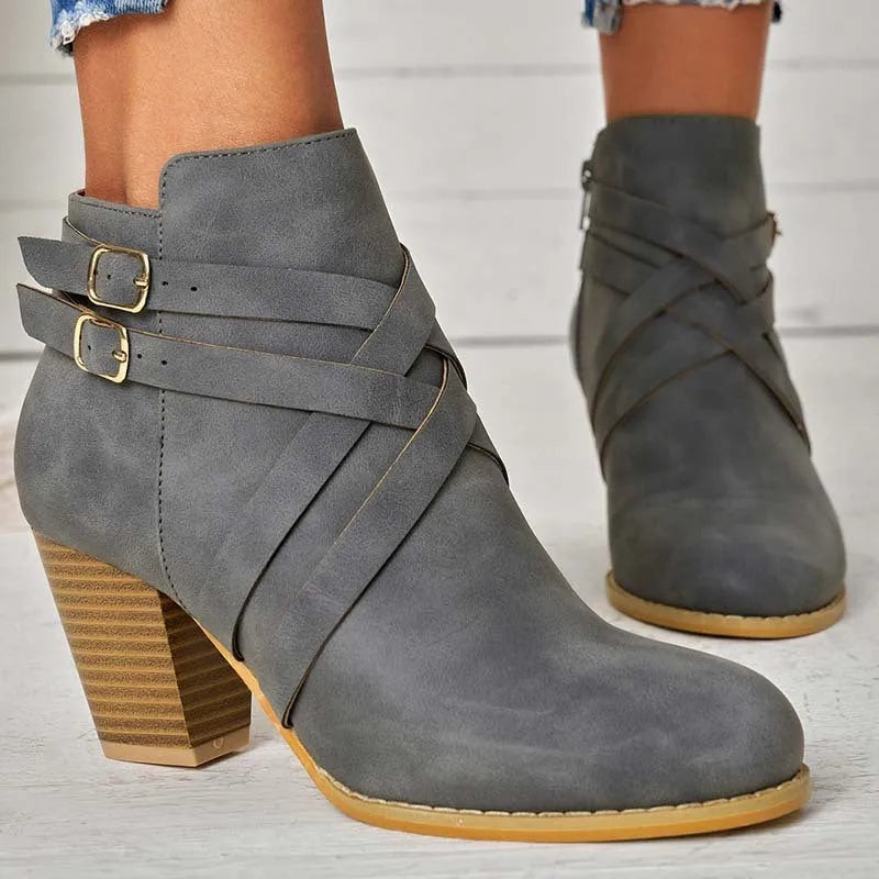 Women's black short boots with a 7cm stout heel and side zip fastener on a rubber sole.