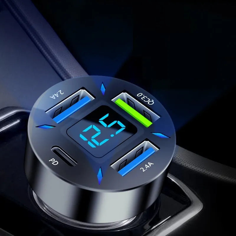 Black 4-port USB car charger with digital display plugged into a vehicle cigarette lighter socket.