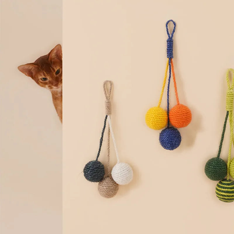 Cat teaser stick toy set with wand and three colourful catnip balls on blue background