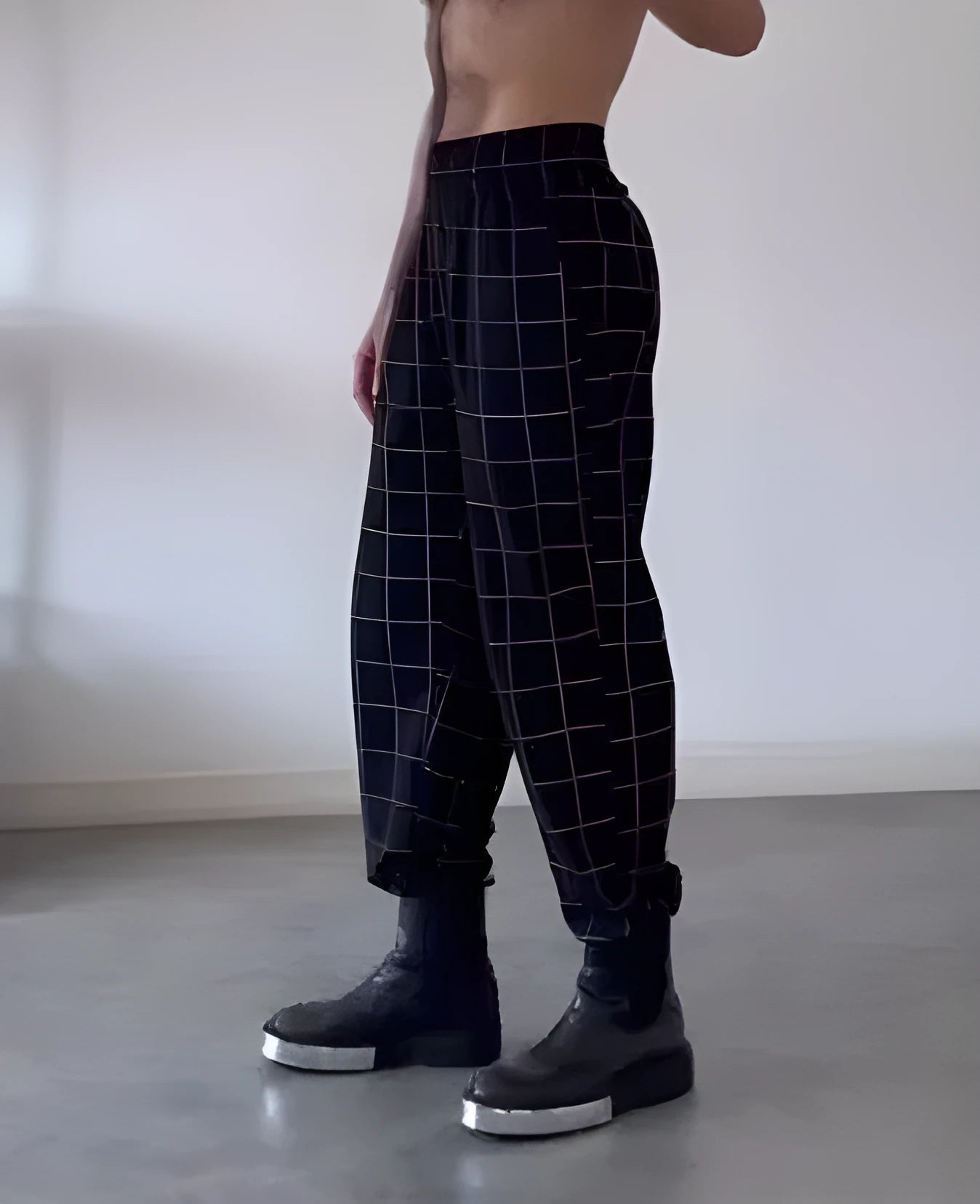 Men's plaid check trousers with apron front panel showing elastic waist and button fly