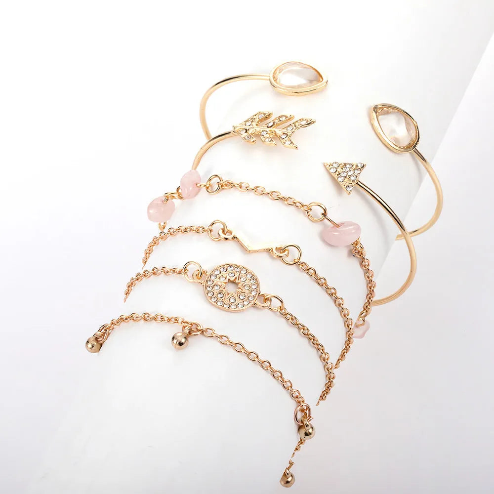 Gold-coloured zinc alloy bracelet set with arrow, water droplet, and V-shaped charms