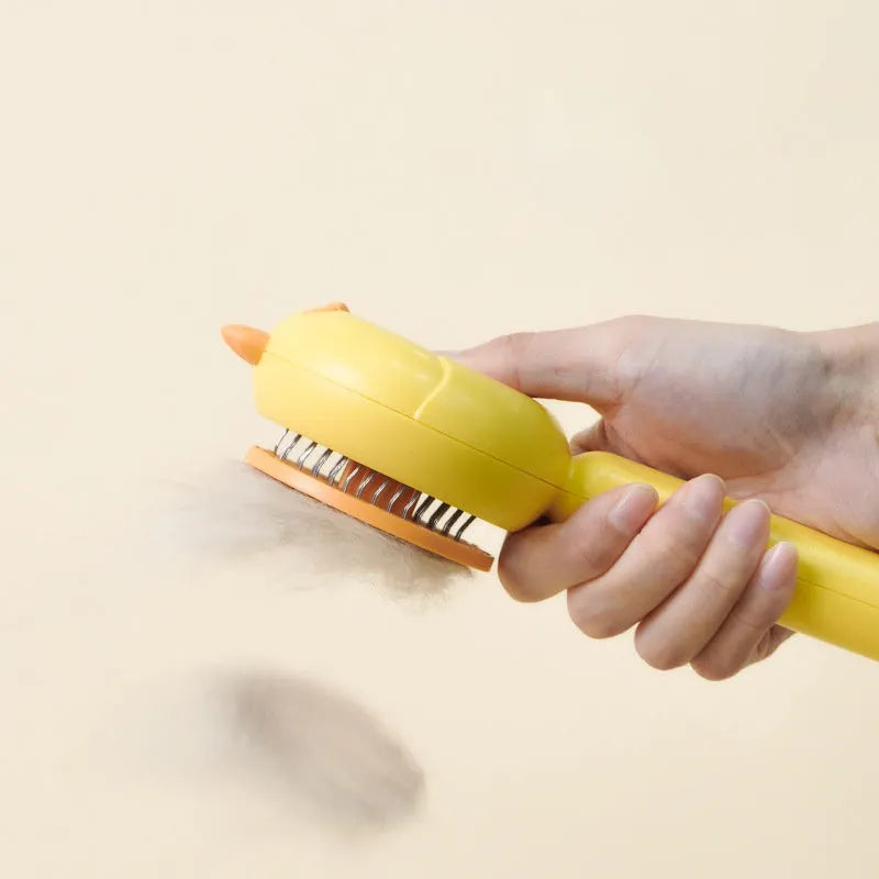 Purple pet grooming brush with self-cleaning button and stainless steel bristles on a white background