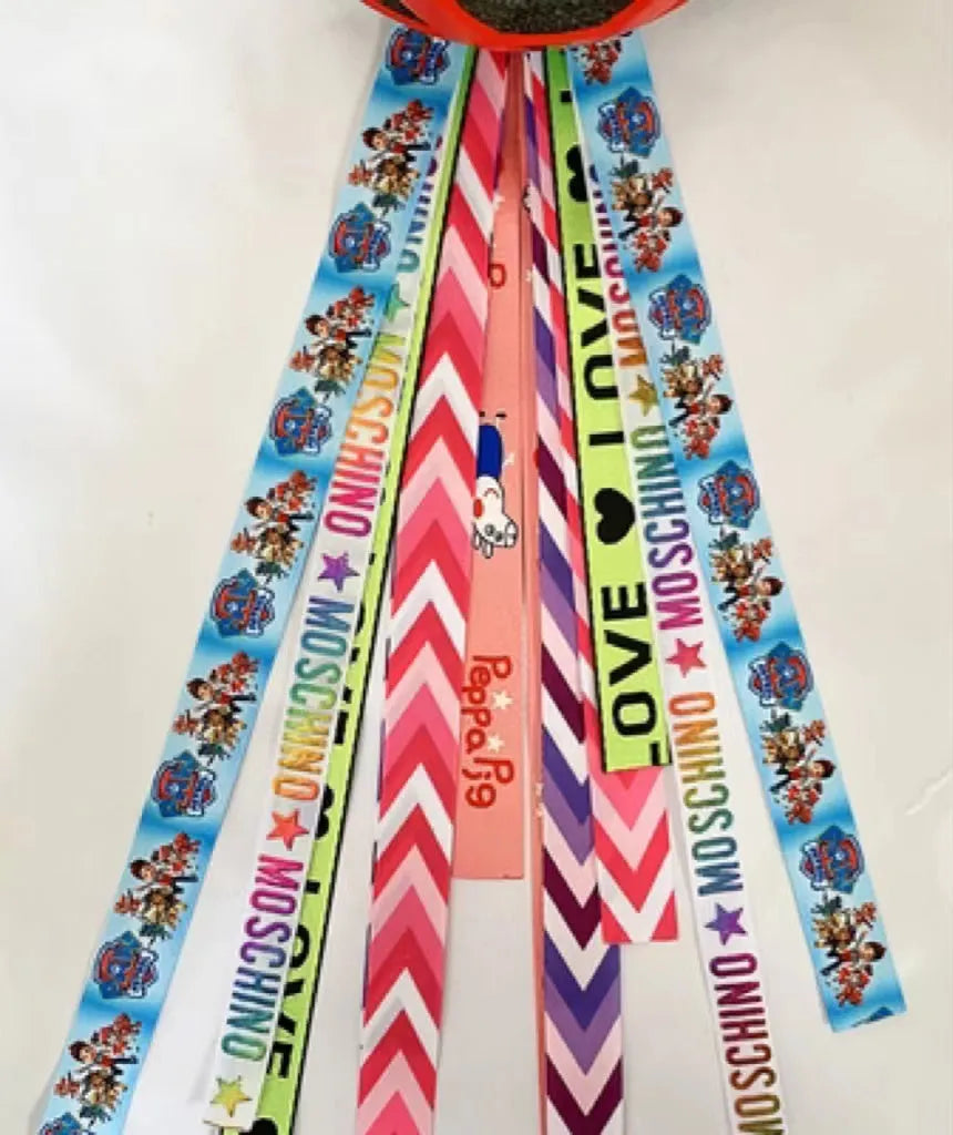 Close-up of a colourful decorative ribbon streamer attached to a child's helmet for roller skating or skiing.