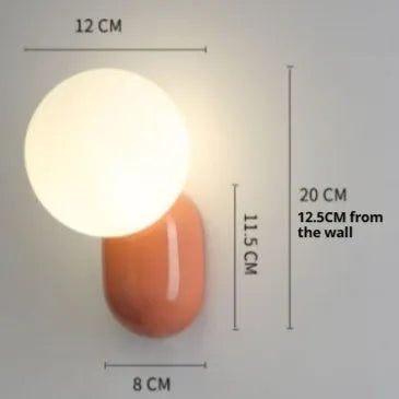 Nordic bedside wall lamp in black with acrylic shade and resin body