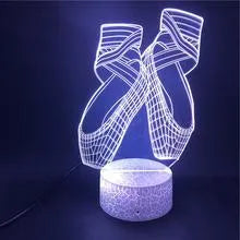 3D acrylic ballet shoe night light with colourful LED illumination on ABS base, remote control beside it