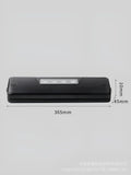 Black compact automatic vacuum sealing machine for home food preservation on a kitchen counter.