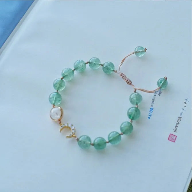 Handcrafted strawberry quartz crystal bracelet with green moon beads and peach blossom Hetian jade charm on adjustable string