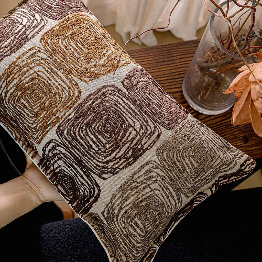 Square and rectangular pillow covers with abstract cream and coffee coil pattern on polyester fabric.