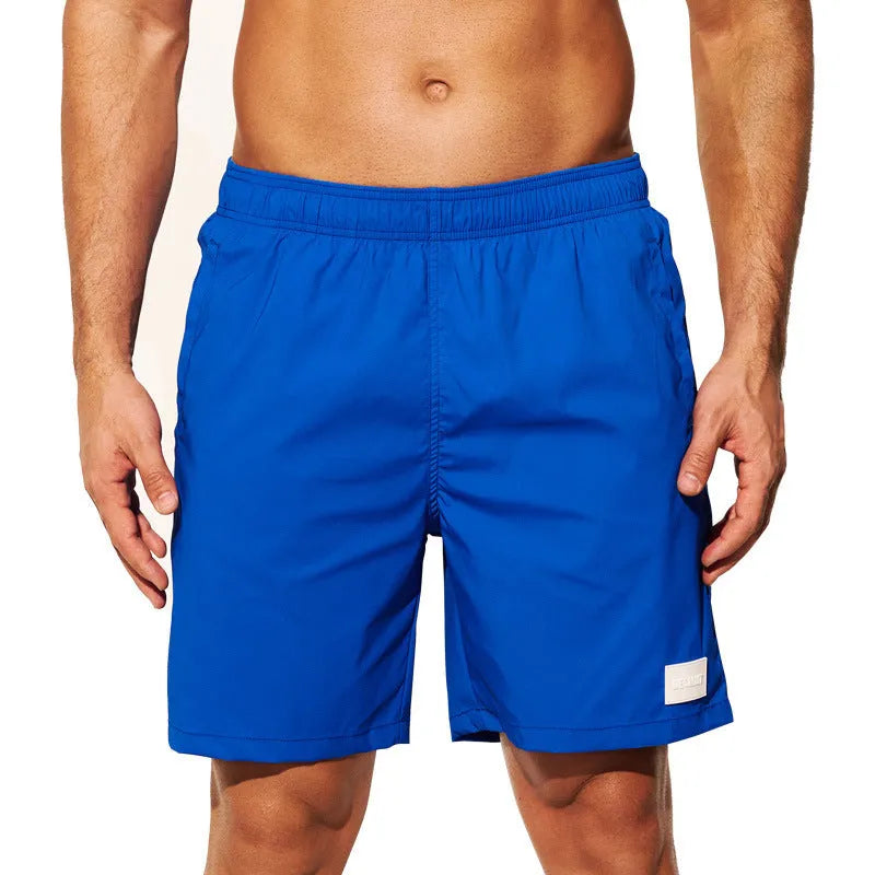 Men's solid colour quick-dry nylon sports shorts on a beach background