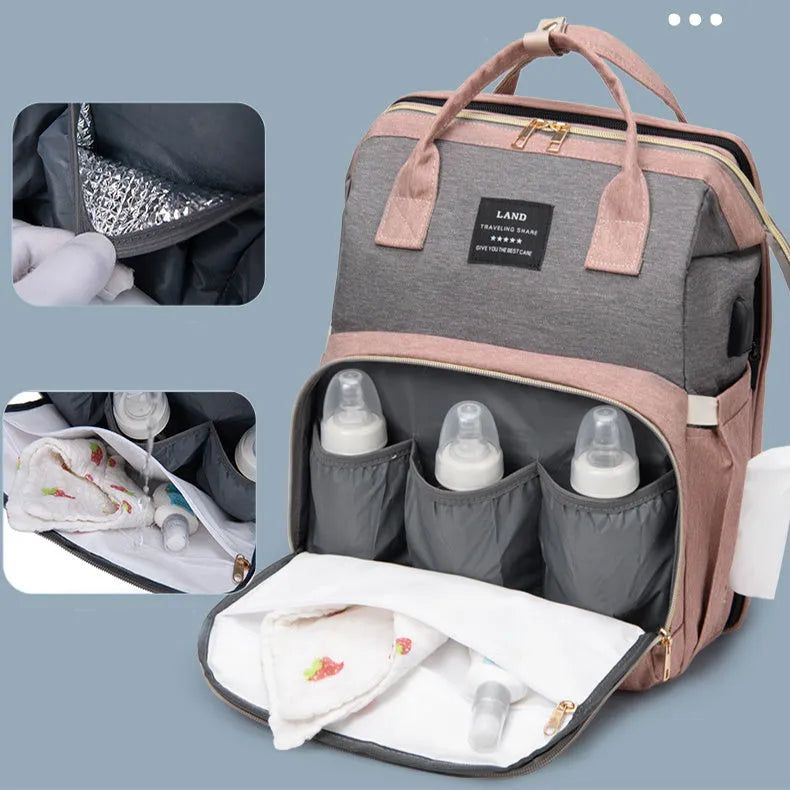 Large capacity insulated baby crib backpack in pink grey with double shoulder straps and outer pocket on white background