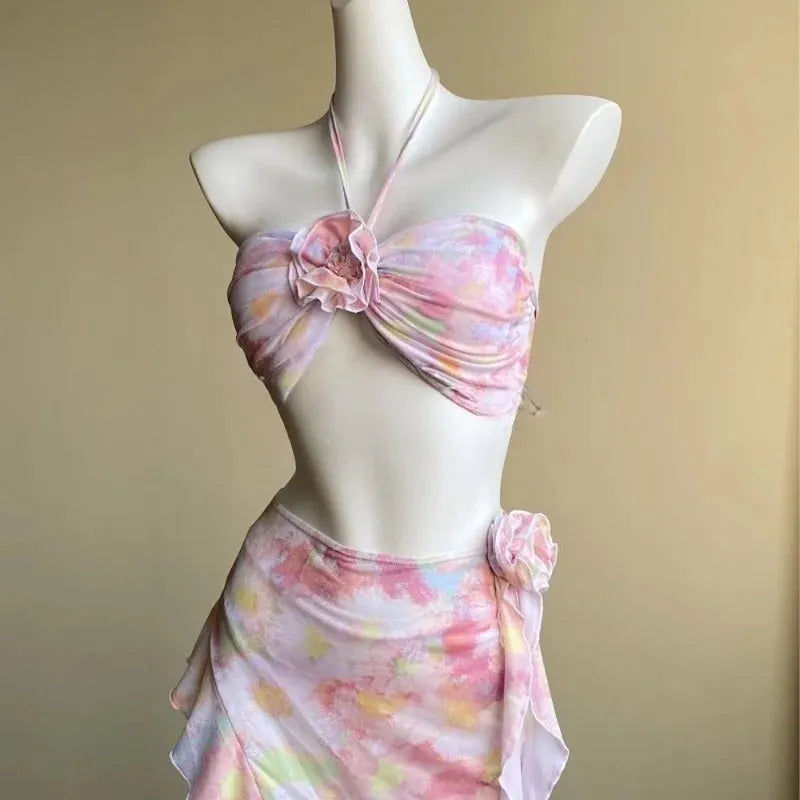 Women's floral split skirt-style swimsuit bikini three-piece set in pink with top, skirt, and panties