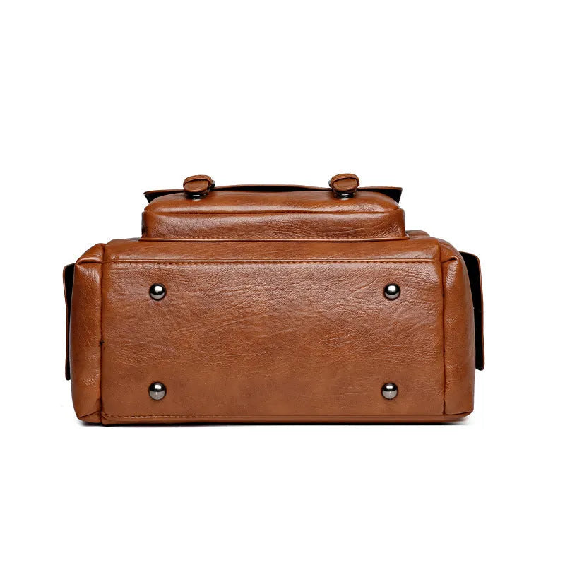 Vintage messenger bag in horizontal square shape showing contrast stitching details and shoulder strap