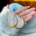 Matte gold geometric ellipse alloy earrings with electroplated finish, vintage French cold wind style for women