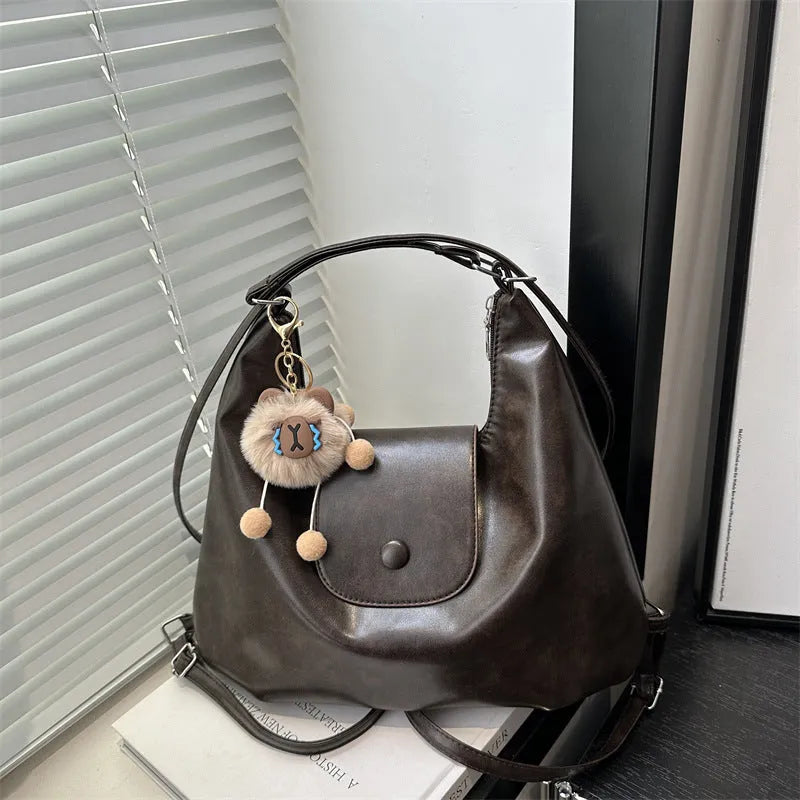 Large capacity PU leather commuter backpack with single shoulder strap in horizontal square design